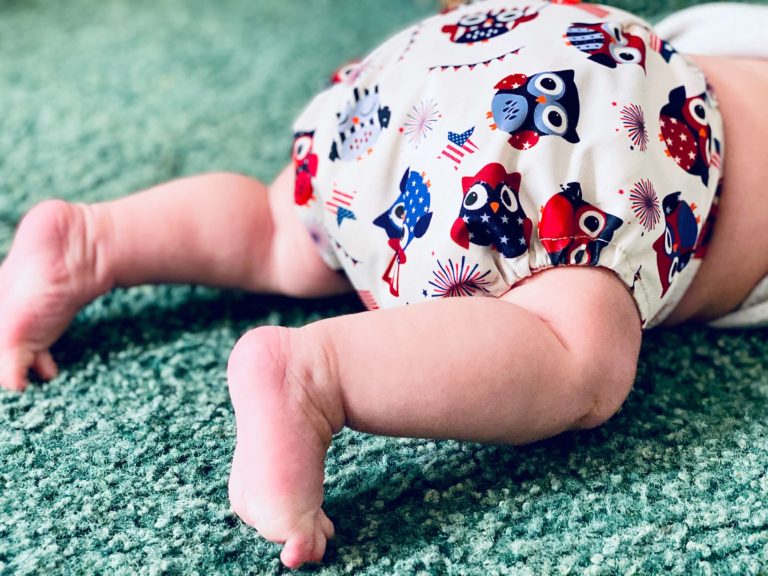 a baby in a diaper with owls