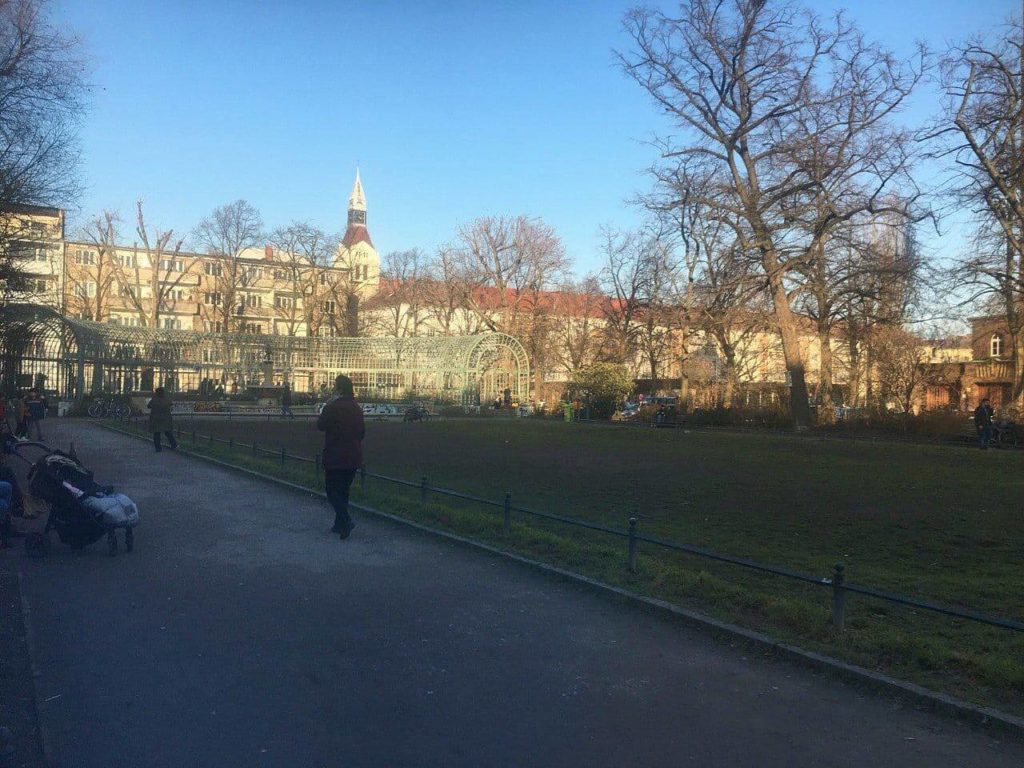 a small park for families in Neukölln, with a fence-like tunnel, houses in the back