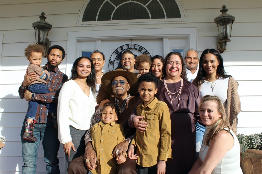 a big family in front of a house