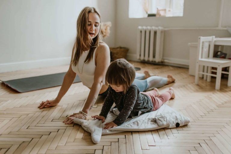 a mom and her daughter sitting in a split