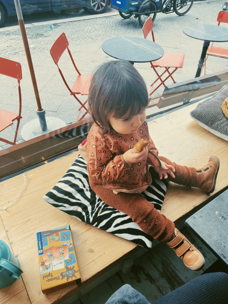 kid enjoying a croissant at Peggy Bee